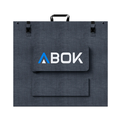 ABOK ASP400 foldable 400W solar panel shown closed from the rear with carry handle, buckles, and cable pouch.